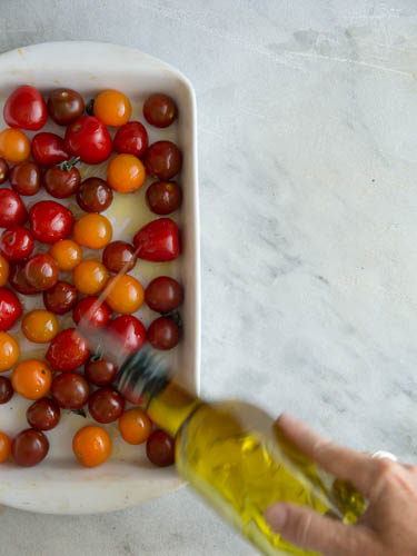 Oiling tomatoes for roasting- A Stack of Dishes