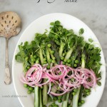 asparagus and garden pea salad, spring greens, spring vegetables, a stack of dishes